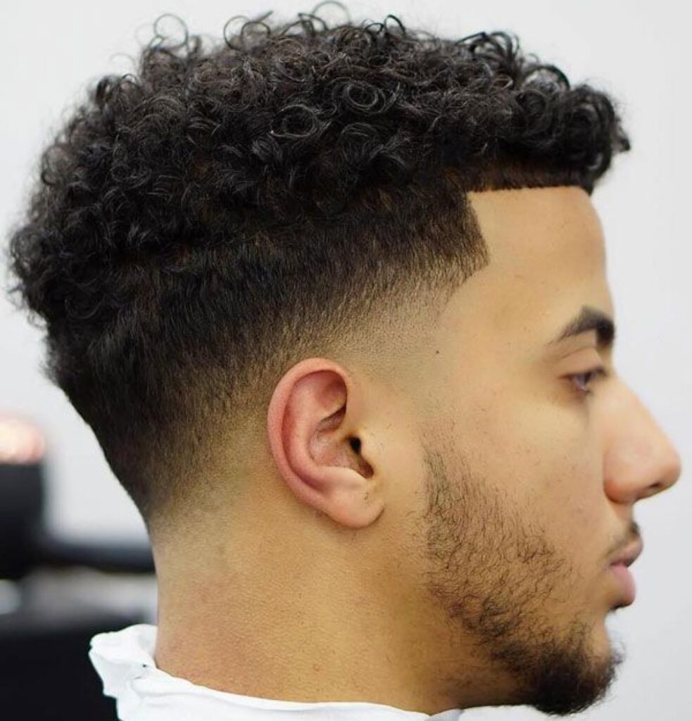 Curly Low Fade with Temple Design Faded into Hair